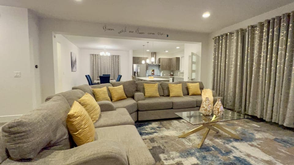 Living room with sectional and coffee table, smart tv