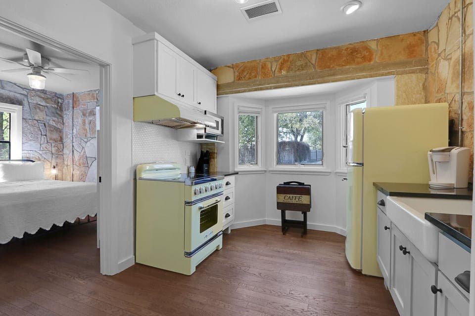 Walking from the living room into the full kitchen