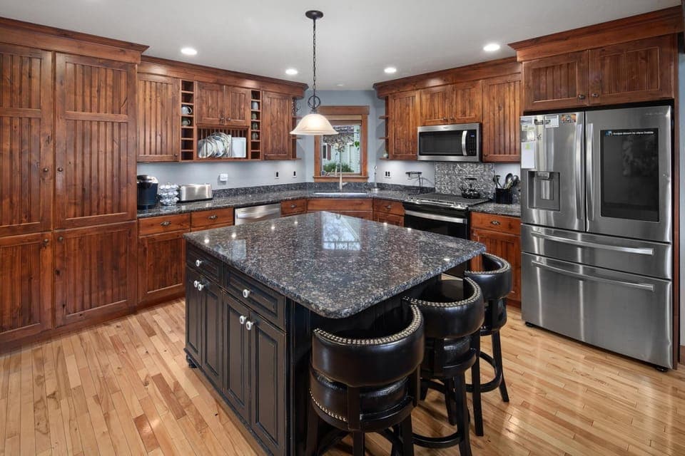 The open concept kitchen fully stocked with cookware, state of the art appliances, and more!