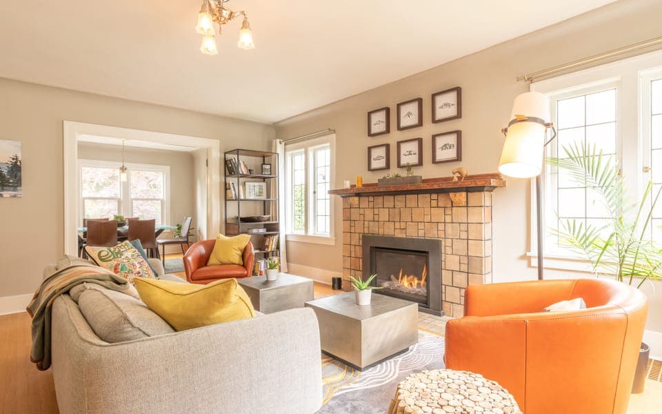 Cozy ground floor living room with gas fireplace that connects you to dining. 