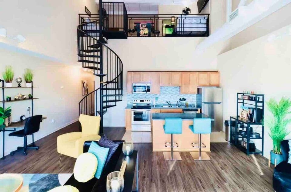 Capture the kitchen's charm and the elegant spiral staircase guiding you to the loft in one delightful snapshot.





