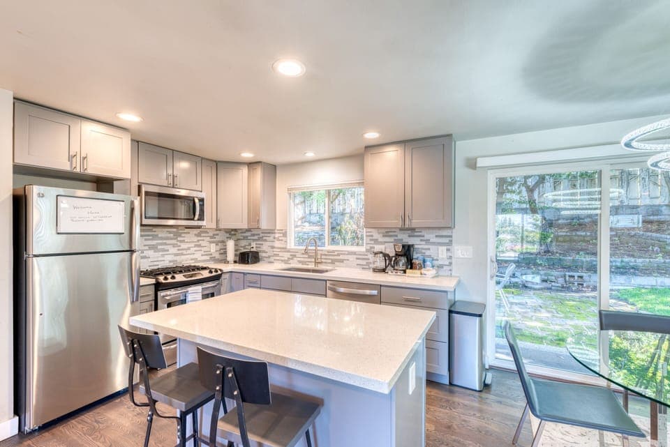 Contemporary kitchen with stainless steel appliances and quartz counter top