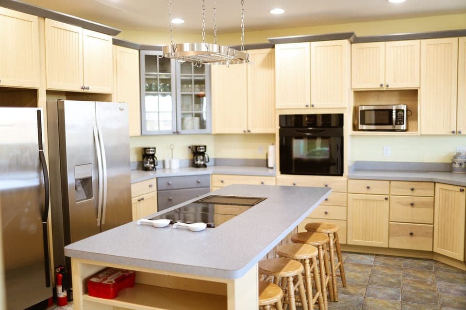 The center island of the kitchen provides additional dining space for guests. 