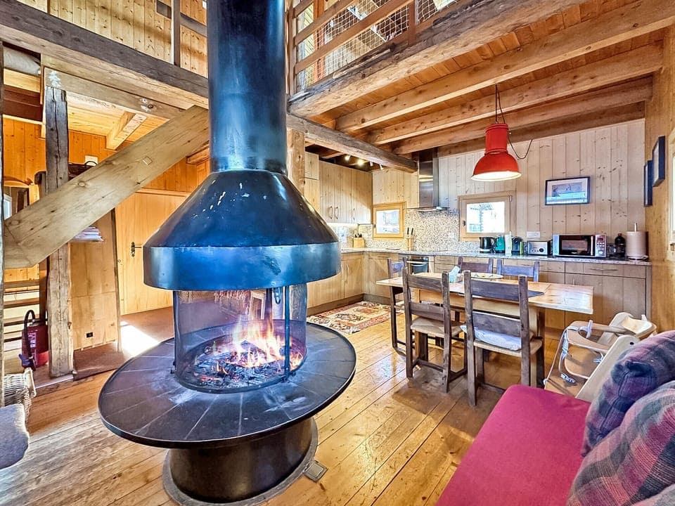 Main room on the ground floor with cosy central fireplace.