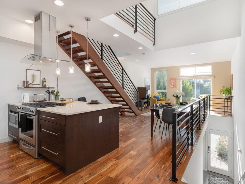 Living, dining and kitchen spaces with beautiful lofted ceilings 