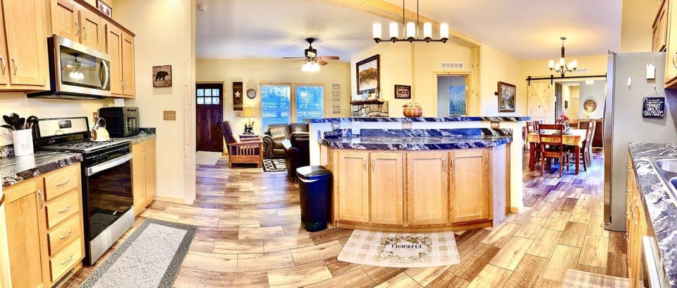 The expansive kitchen, featuring 9' bar, opens to the living and dining rooms. 