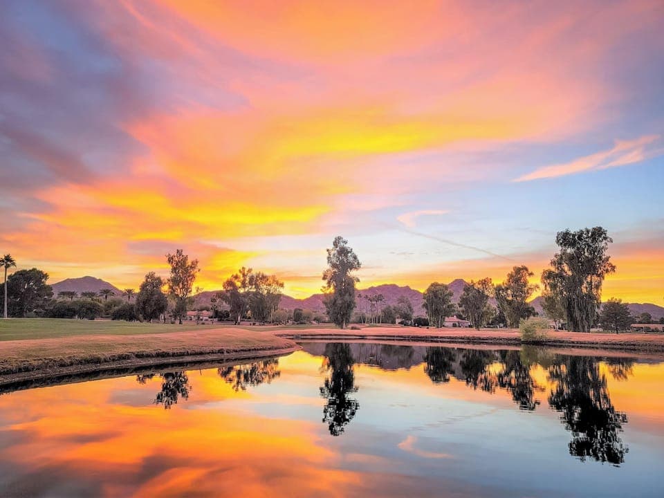 Sunset amidst ponds and mountains in home's golf course