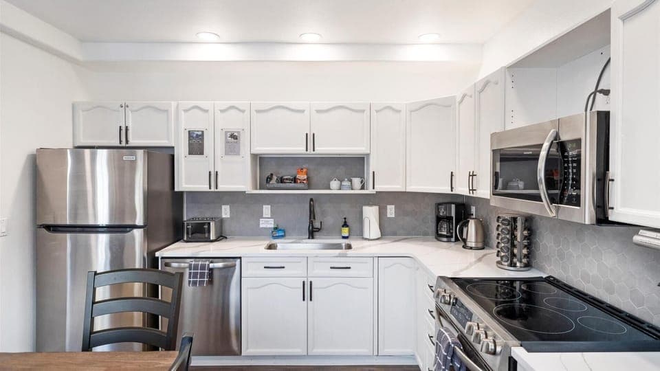 This newly remodeled chefs kitchen features brand new appliances, fully stocked with all the cookware and kitchen utensils.