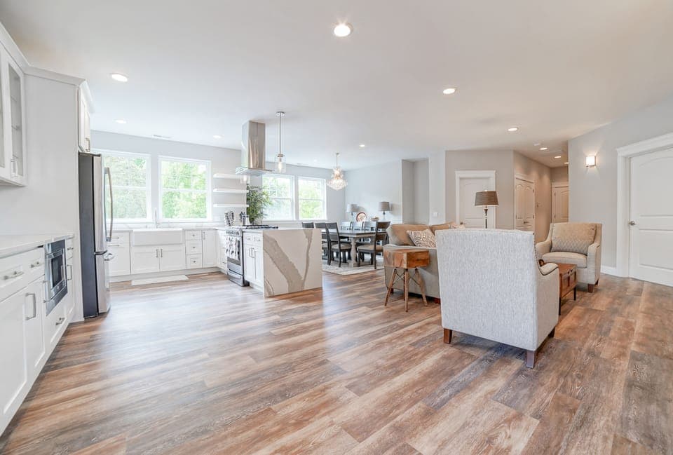 Open concept kitchen, dining area, and fire side lounge.
