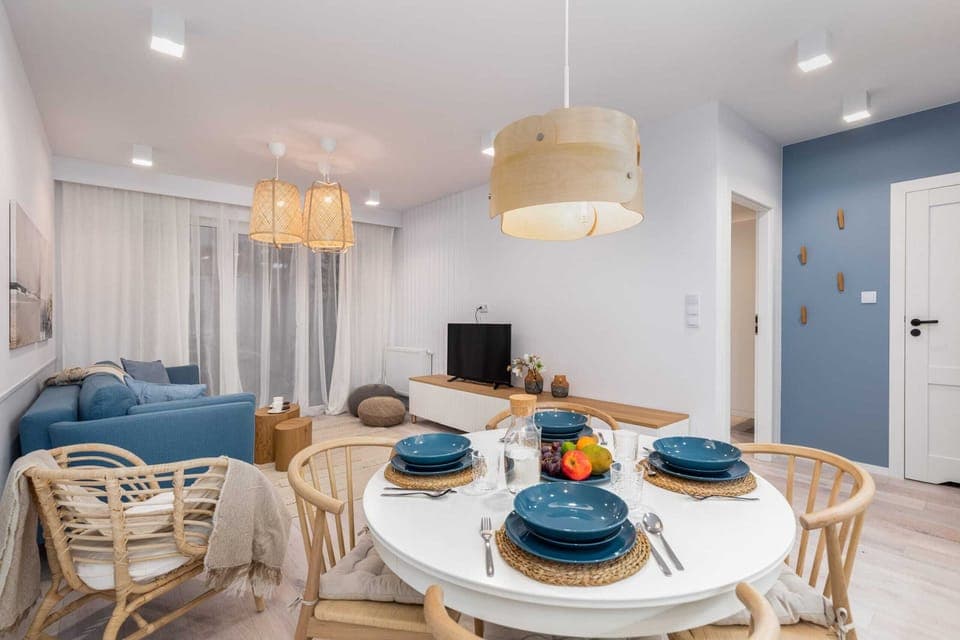 A larger perspective of the open-plan living area, featuring the dining table and comfortable seating arrangements.