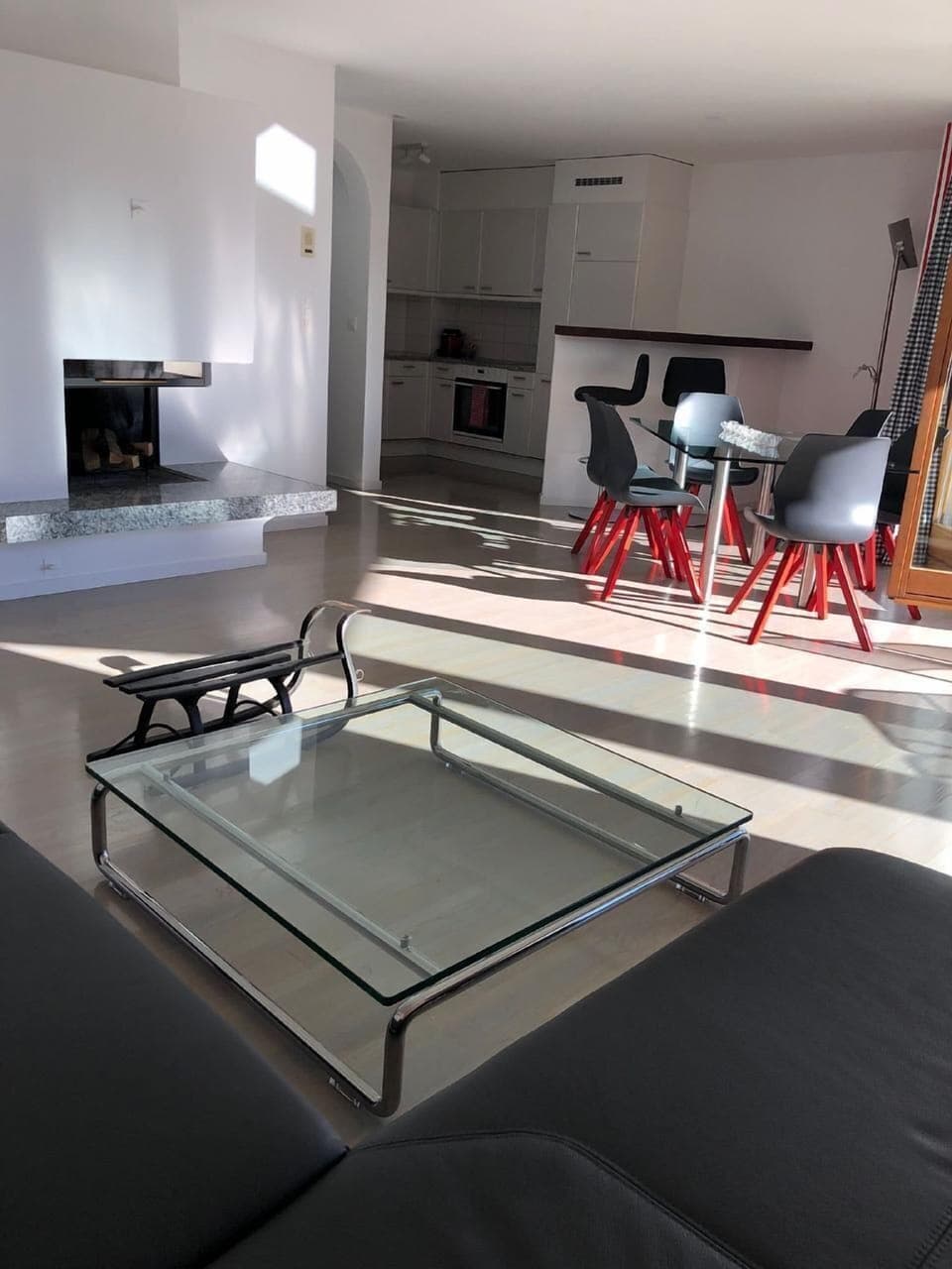 Living room with fire place, open kitchen and front balcony