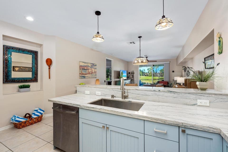 Full kitchen with marble style counters and stainless steel appliances