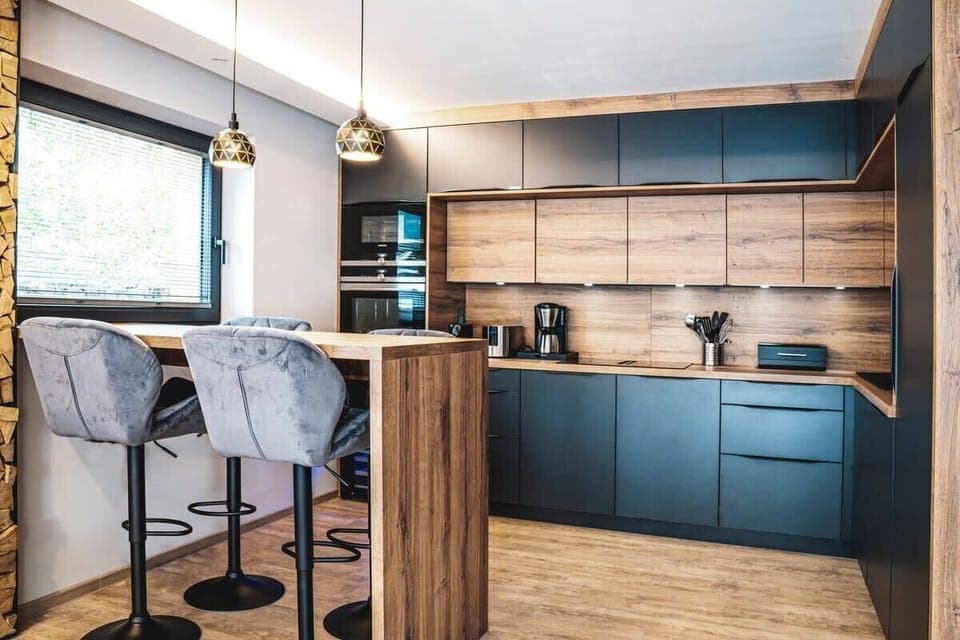 The spacious designer kitchen with Siemens appliances, downdraft induction cooktop, wine cooler, dishwasher, large refrigerator with small freezer compartment, and a large variety of toasters, blenders, Nespresso and other coffee machines.