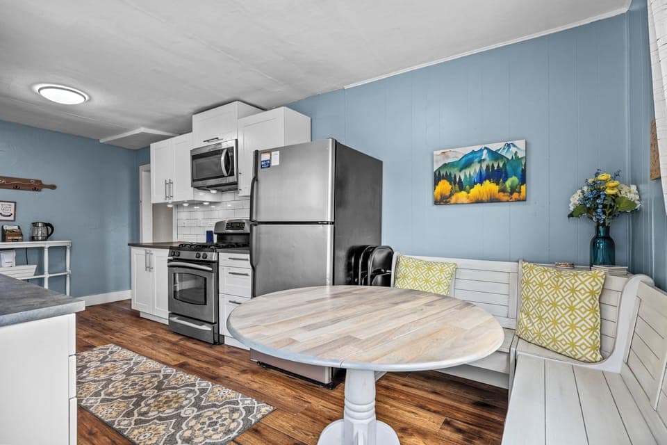 Dining area with bench seating and additional chairs. 