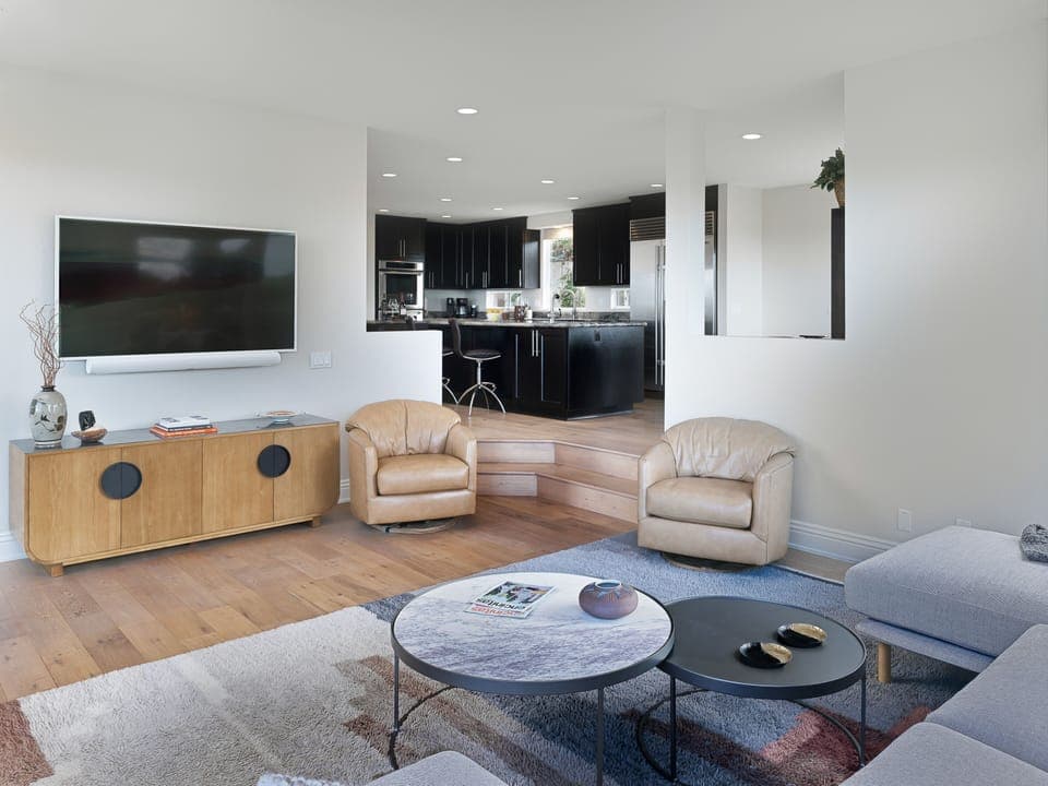 Living room features Smart TV, Sonos ARC Sound Bar, and opens up into kitchen