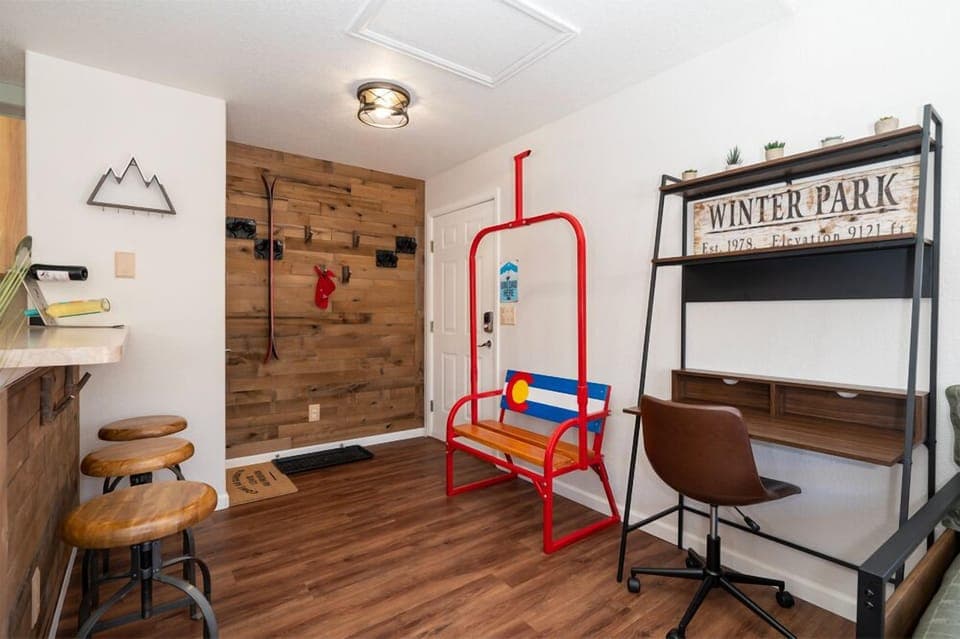Your workspace blends mountain lodge charm with modern convenience, featuring a ski lift chair and rustic wood accents for productive alpine getaways.