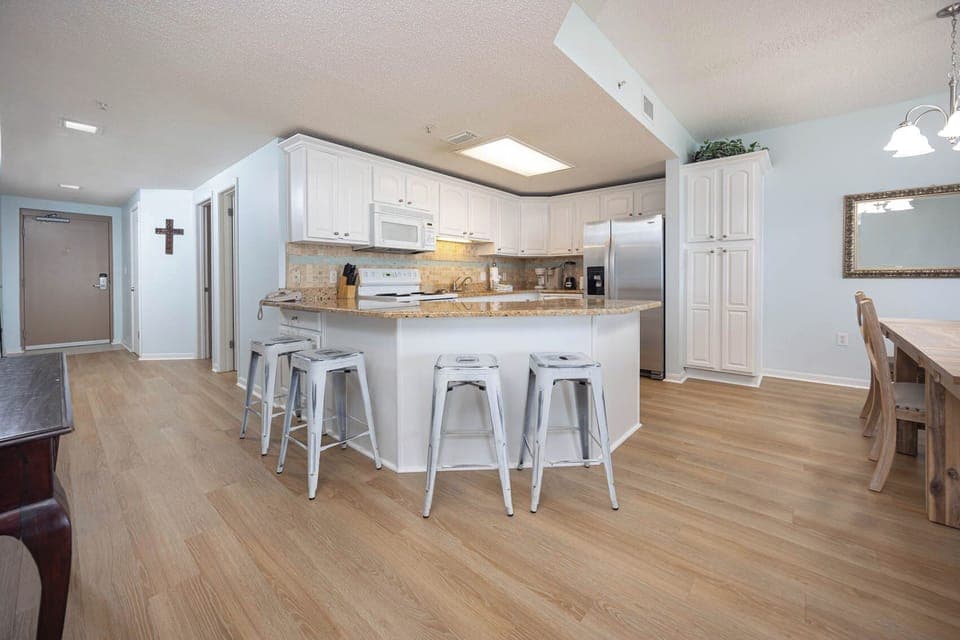 Gather around the stylish kitchen or dining table, enjoying the open layout and inviting atmosphere