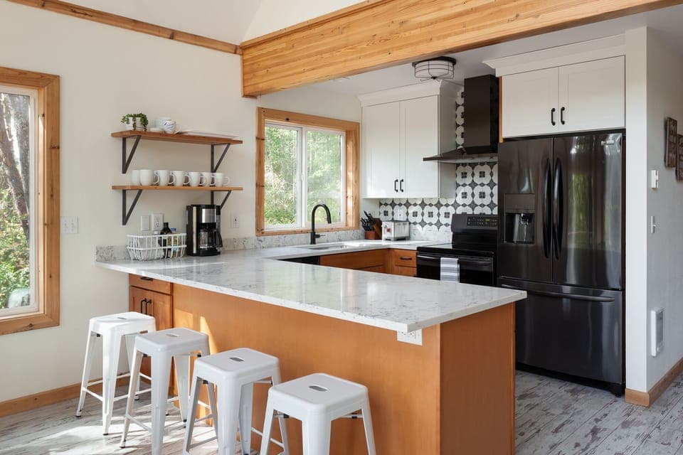 Kitchen with induction range and counter seating for 4.