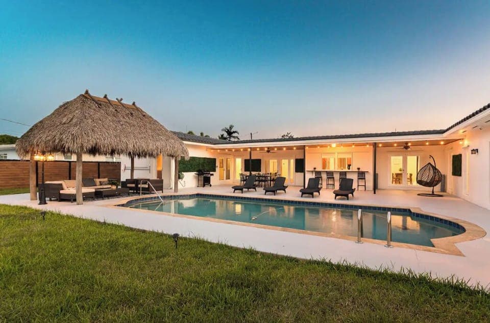 Beautiful backyard oasis with a Tiki lounge and heated pool.