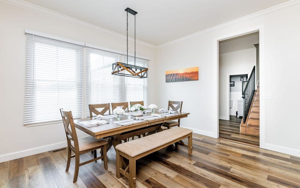 Share meals, laughter, and memories—this modern rustic dining space seats 10 and frames breathtaking countryside views.