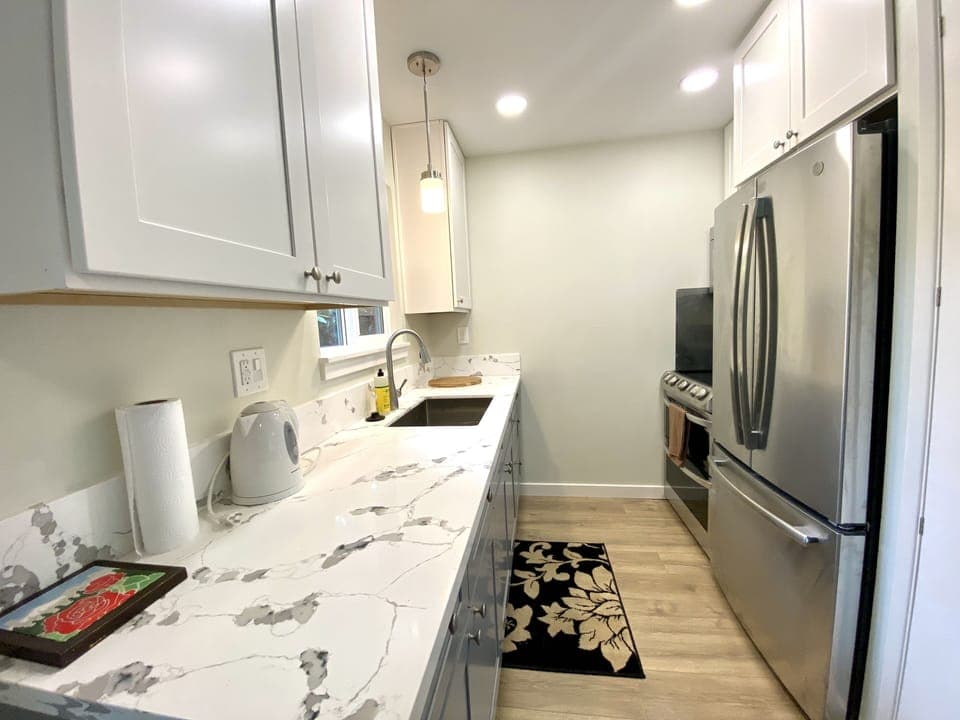 Nice Kitchen with granite countertops, stainless steel fridge and oven. 