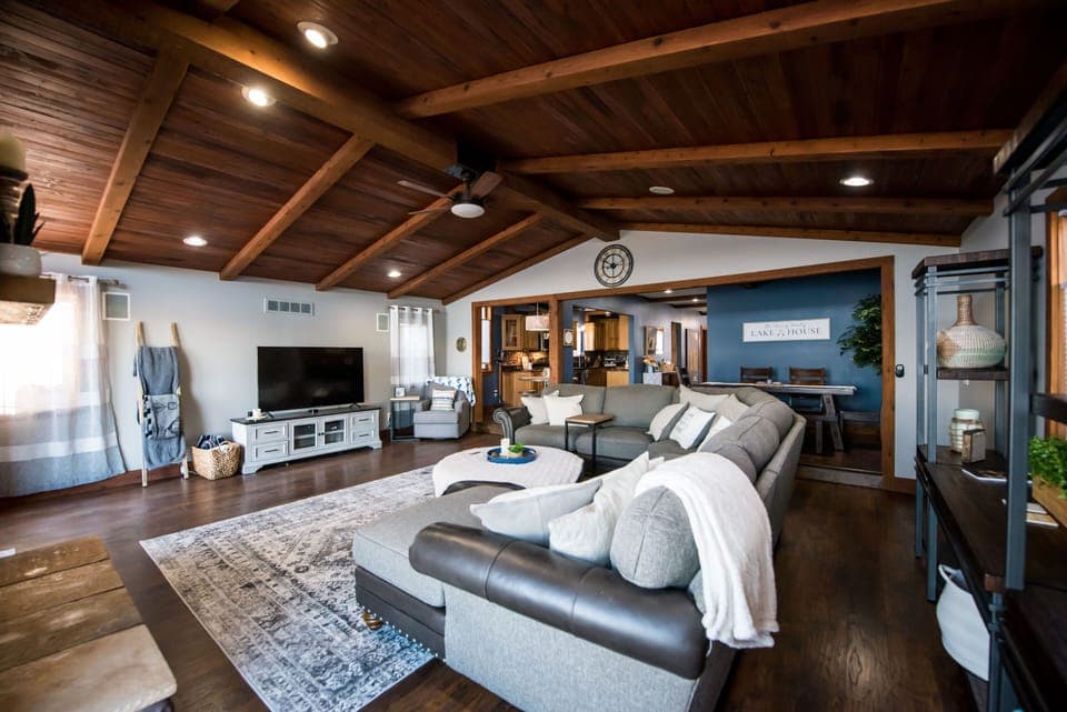 Spacious living room with large sectional sofa, gas fireplace and lake views.