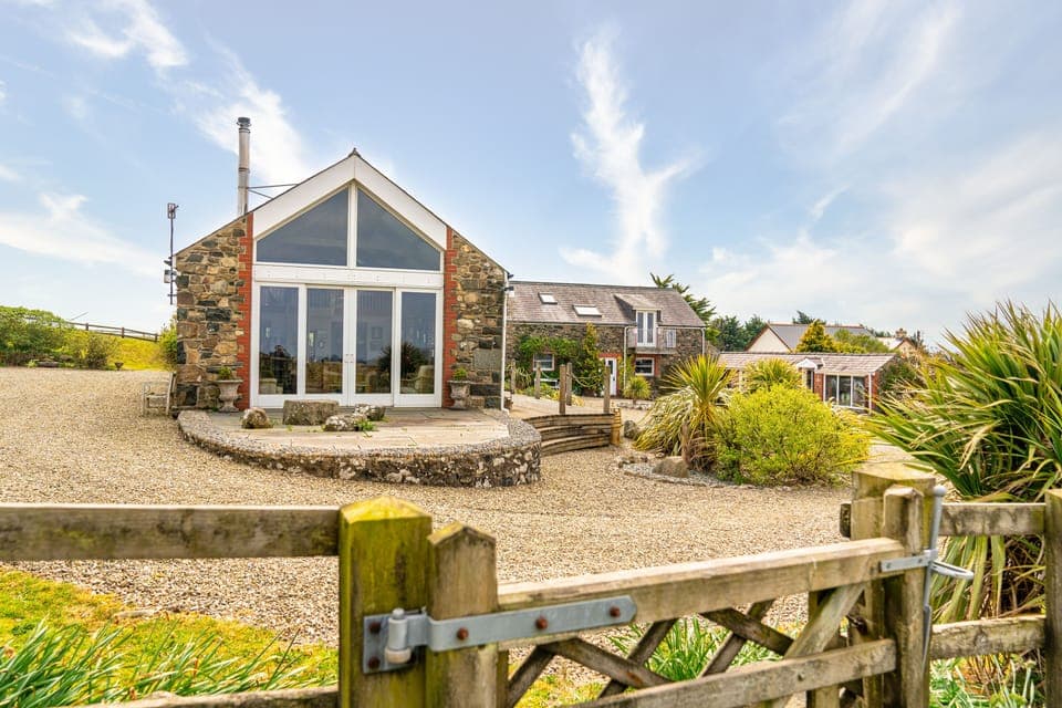 Living room Cathedral window with river pebble terrace. Gate to paddock.