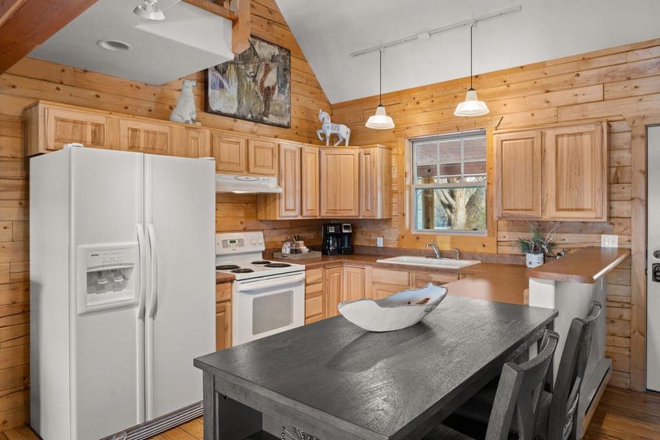 Open kitchen with stove, refrigerator and microwave (no dishwasher). 