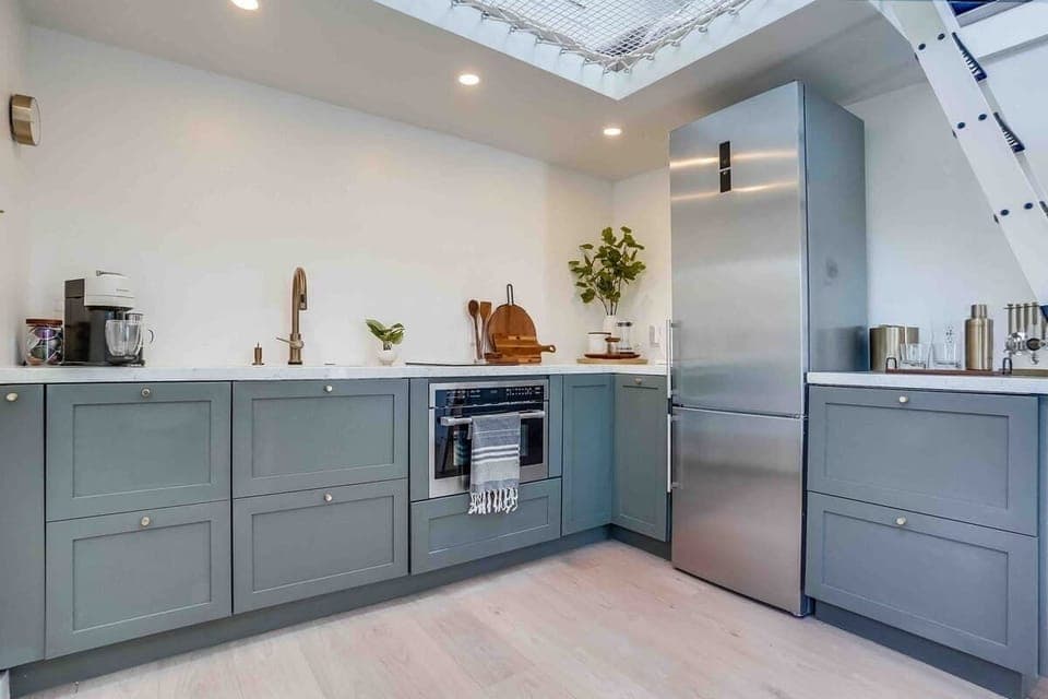 From left to right we have, a Nespresso Maker,  hidden Dishwasher (first set of drawers), stove top, combination microwave/oven, French press station, refrigerator with ice maker, and little bar area. 