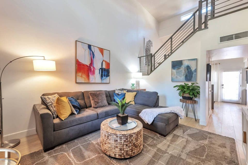 Living room with sectional sofa and 75" Smart TV w/ cable