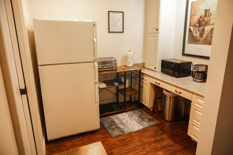 full-size fridge/freezer, toaster oven, coffee maker, microwave, kettle, and mor