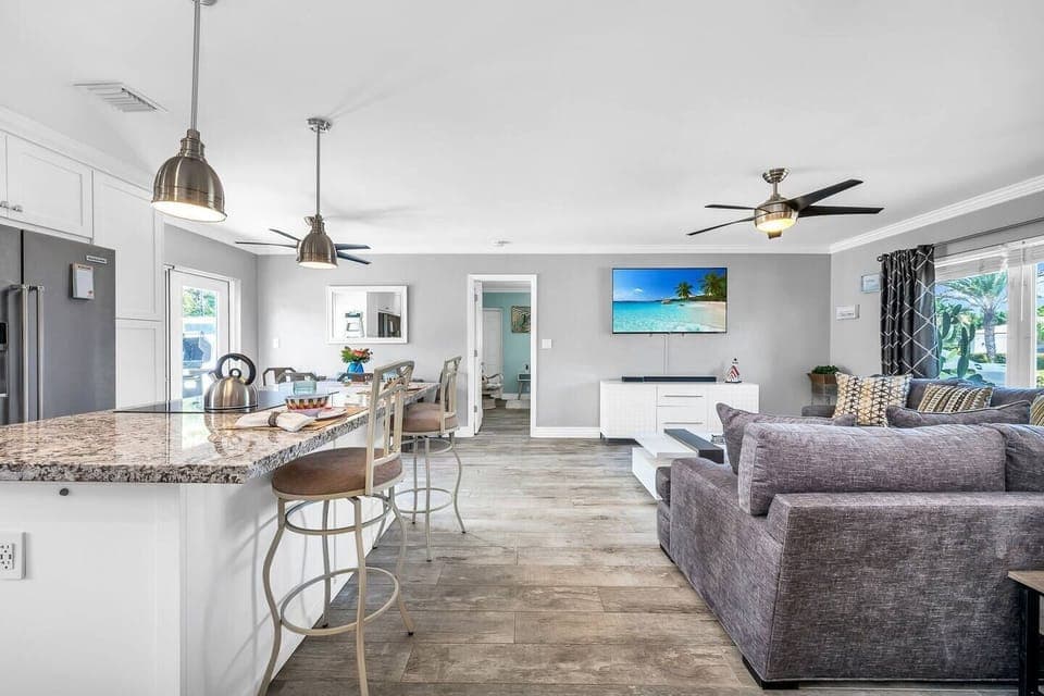 Beautifully updated kitchen with granite tops, shaker cabinetry, induction stove, 2 ovens, toaster oven, Keurig, and drip coffee maker. Service for 8!