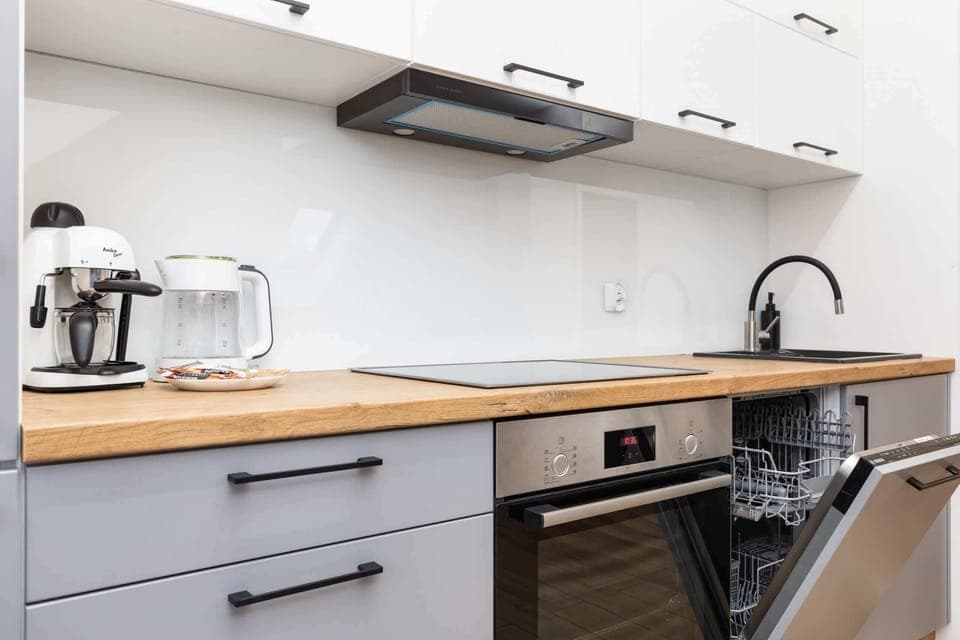 A well-equipped kitchen with modern appliances, including a kettle and toaster.

