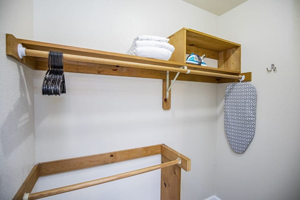 Primary closet, iron & ironing board for guest use. 