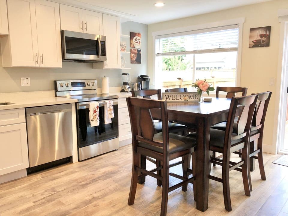 Next to the kitchen you'll find a countertop-height dining table and six chairs.