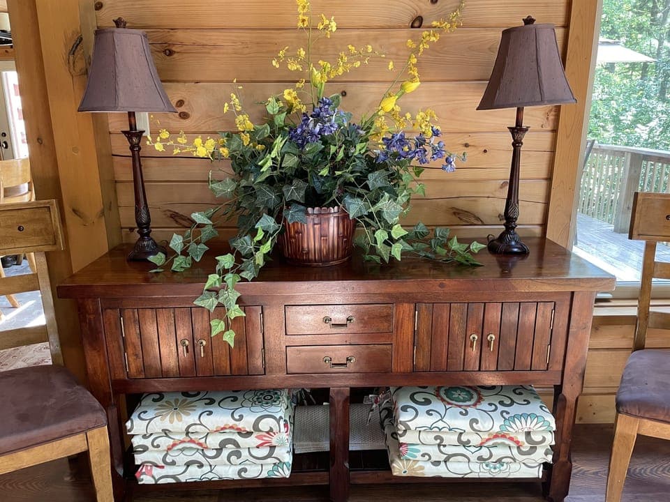 Great Room-Main Level-This beautiful buffet is host to the outdoor table cushions and placemats.  There's also a battery-powered blower to the right of this for your convenience to handle Mother Nature.