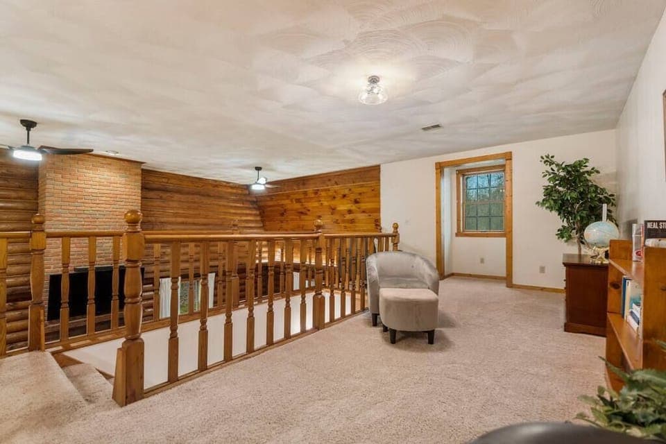 loft area with seating an small television to play video games. 