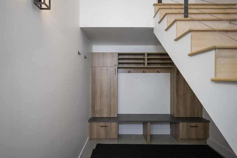 Mud room can be found under the stairs in the entryway