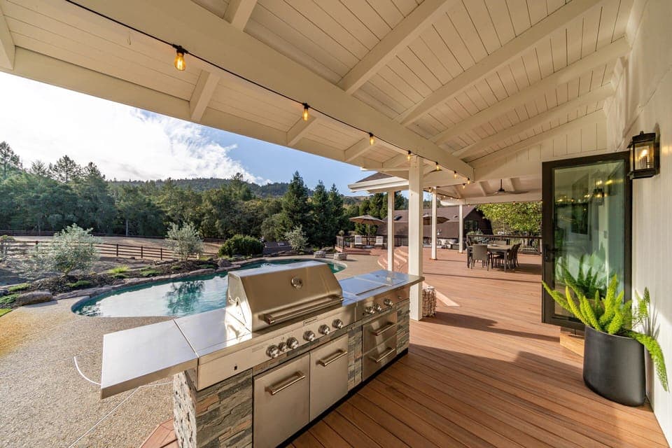Spacious outdoor kitchen and dining area with scenic views