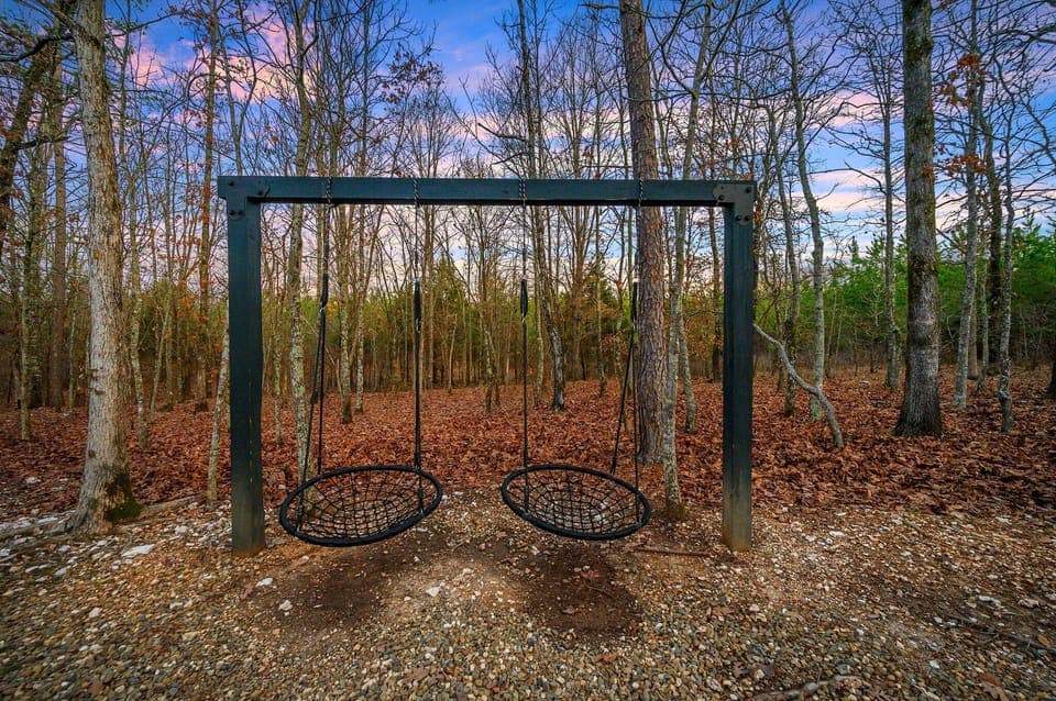 Outdoor Retreat: Embrace nature on relaxing swings surrounded by enchanting woods!