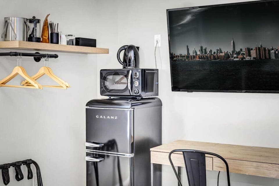 A functional space featuring kitchen appliances for added convenience in the bedroom.