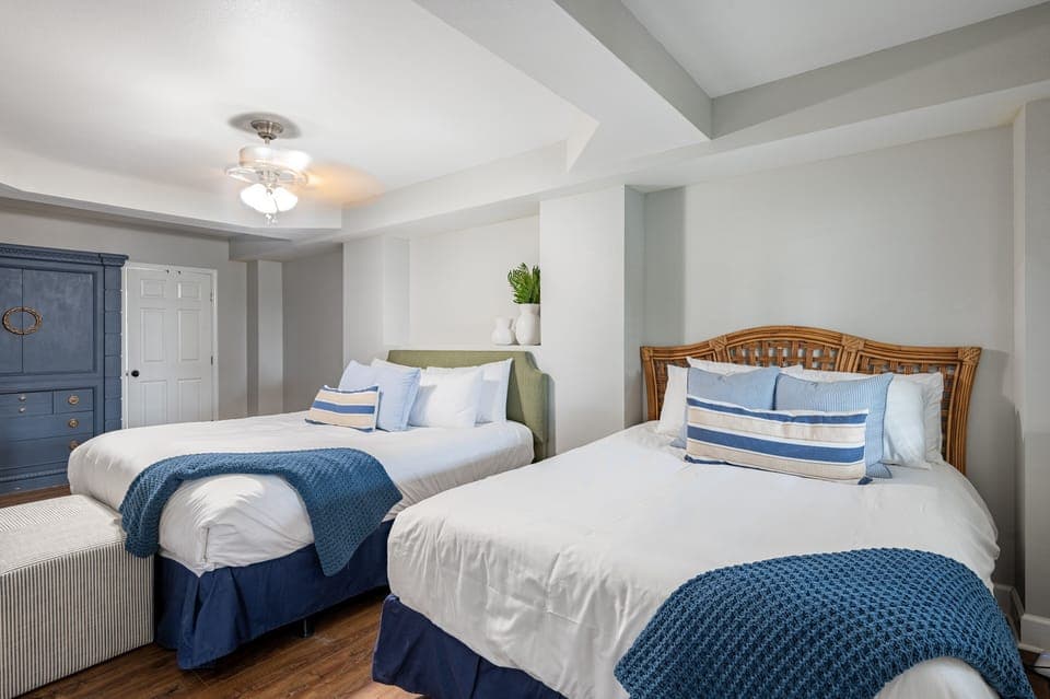Bedroom 6 features two queen beds and an ensuite bathroom.