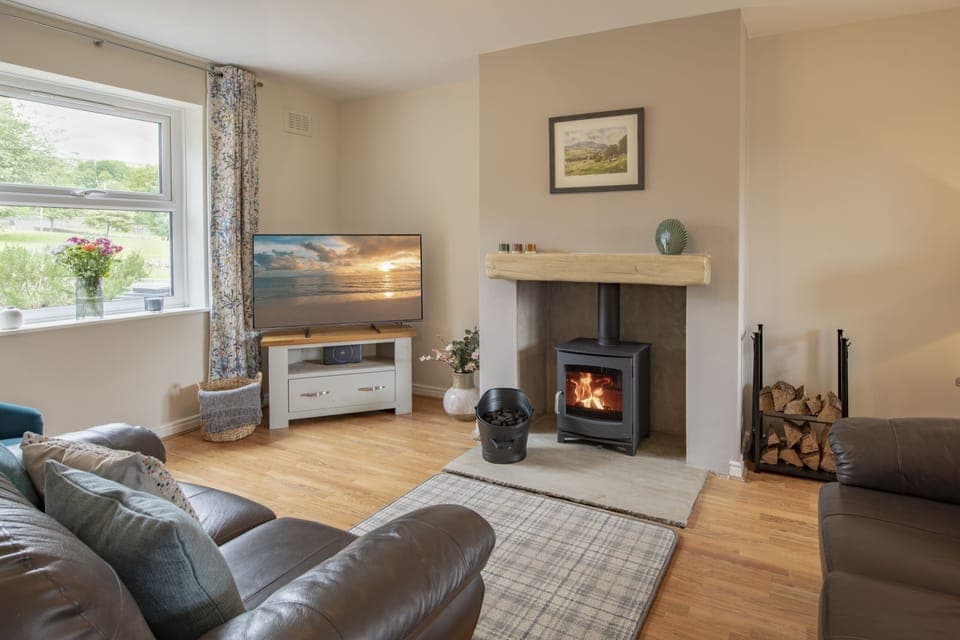 Penhill, Redmire: Cosy sitting room with a multi-fuel stove