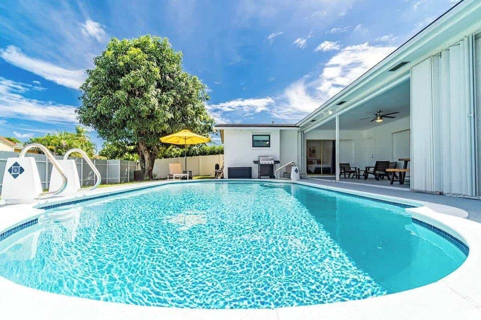 "Sparkling private pool with crystal-clear waters, surrounded by lush landscaping and covered patio seating. This stunning vacation rental offers your own tropical oasis for swimming, sunbathing, and creating unforgettable Florida memories!"