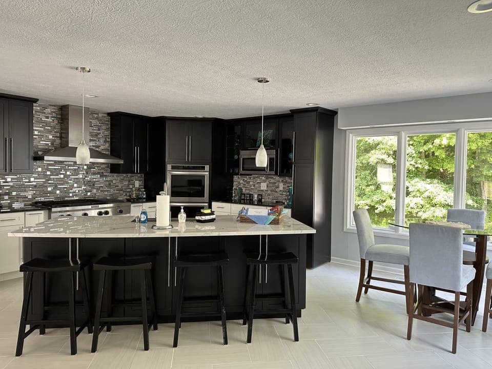 The kitchen with island and 4 barstool and farmhouse sink.