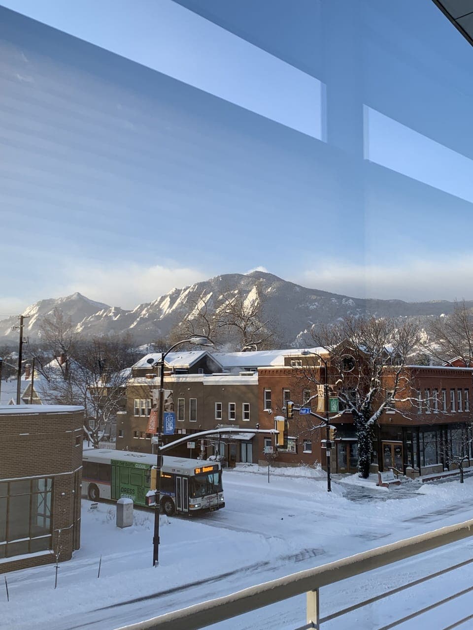 Winter daytime view of Pearl St and Flatirons