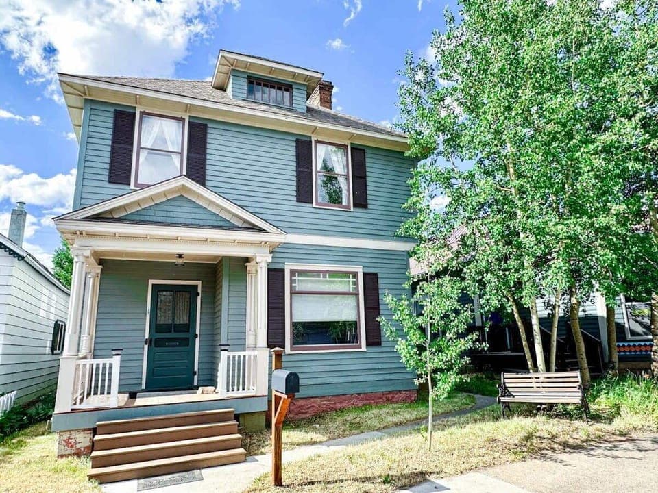 【Exterior — Summer】 1880s Victorian on E 8th — one block from Harrison Ave, wildflower season June through August.