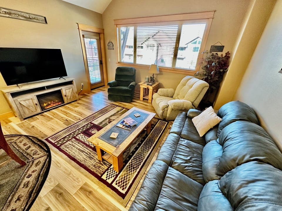 Cozy living area with ample seating & electric fireplace for those chilly nights