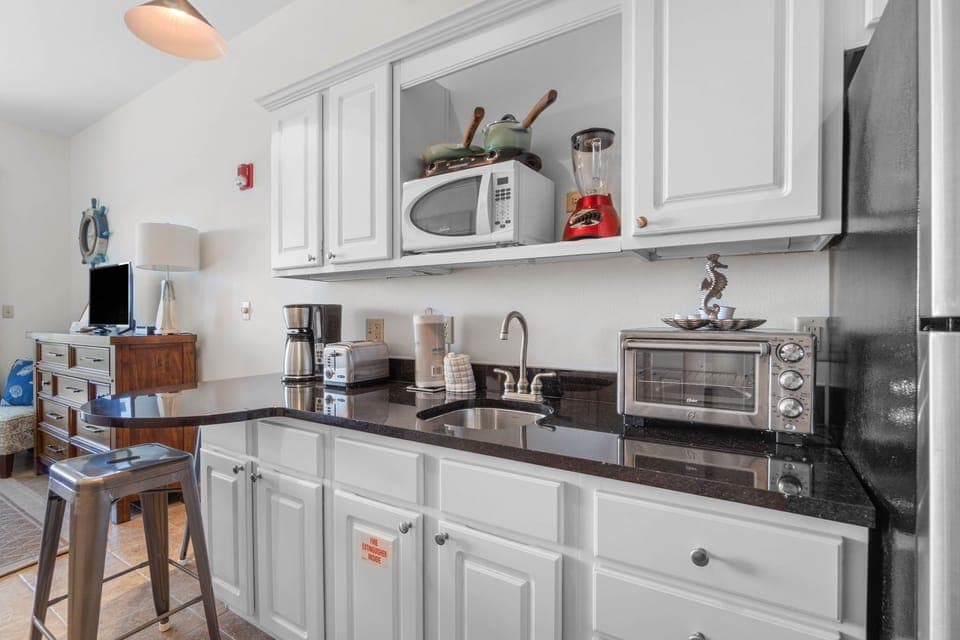 Kitchenette area with microwave and full size refrigerator