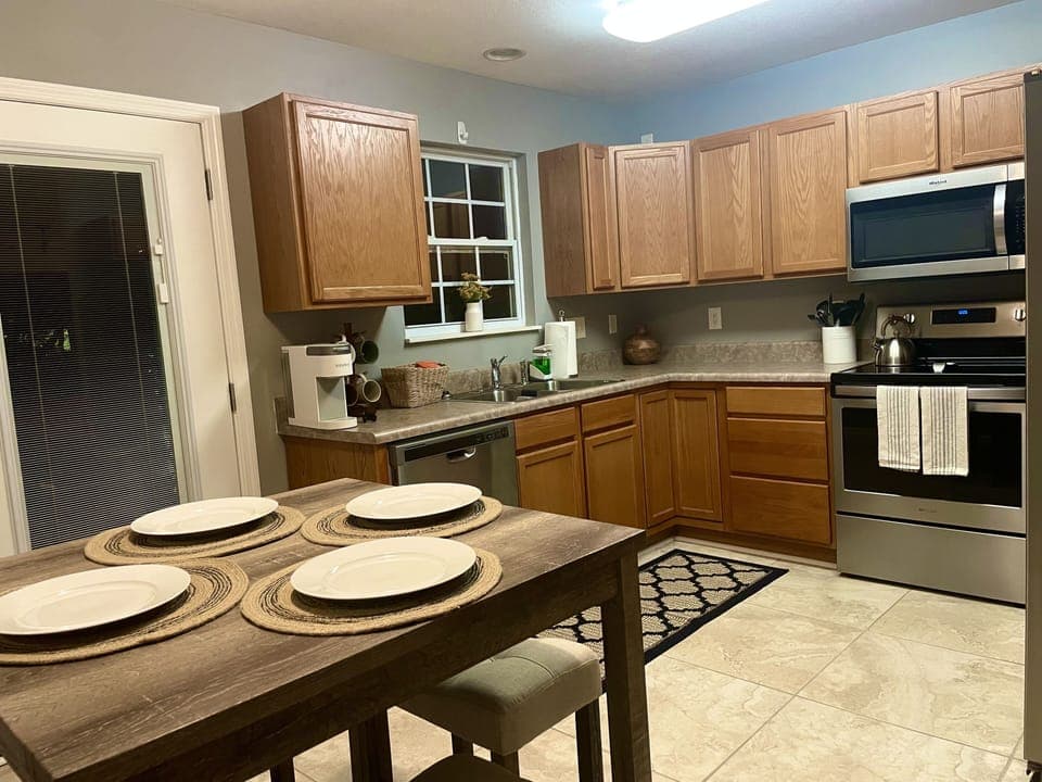 Kitchen w/ access to Patio.  All new appliances and views of trees and greenery